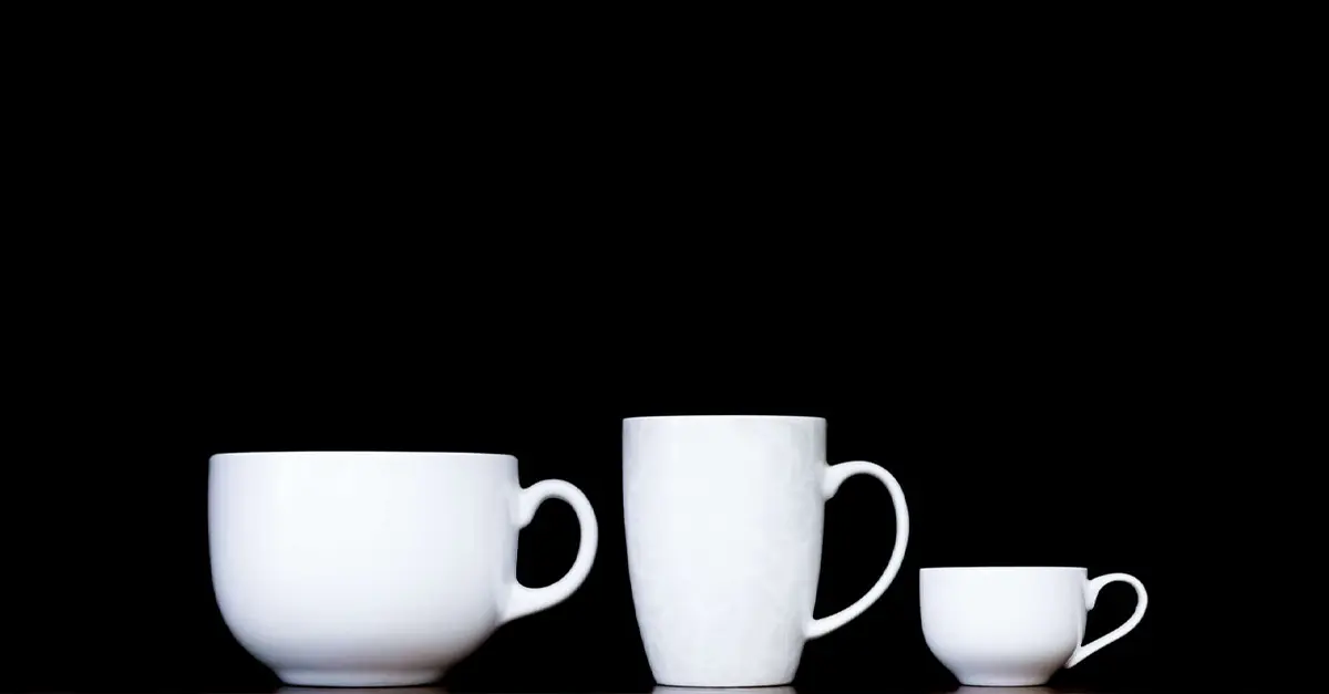 Mugs standing in row in black background